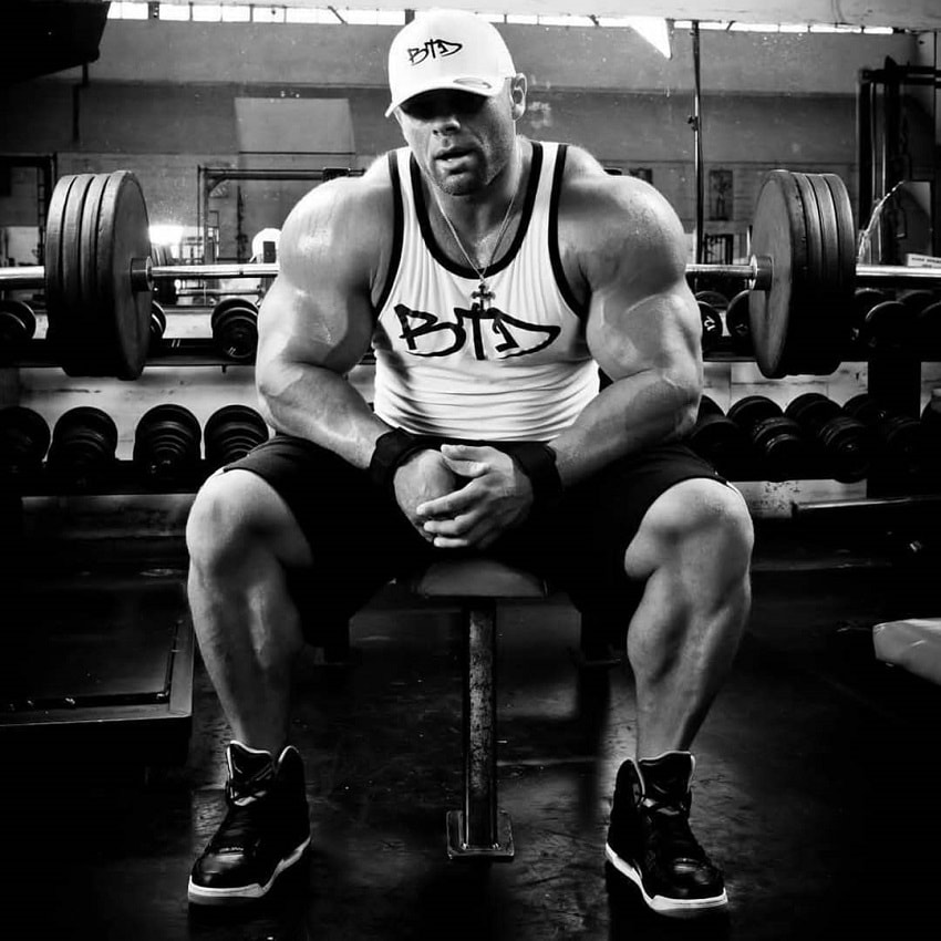 Marius Dohne sitting on a bench in the gym, looking big and strong