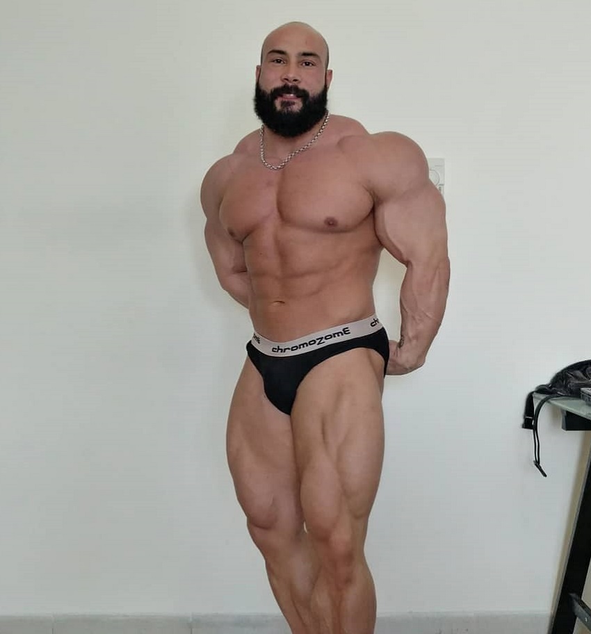 Samir Troudi flexing his huge and swole muscles for the photo