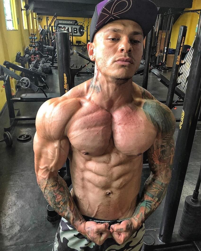 Tiago Toguro flexing shirtless in the gym