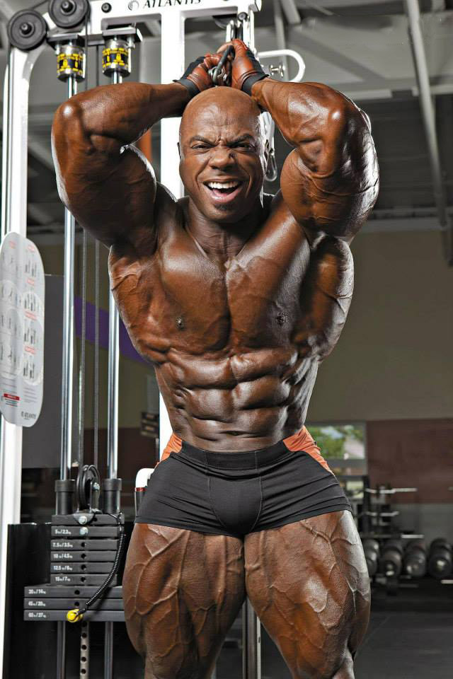 Toney Freeman flexing his abs in a professional bodybuilding photo shoot