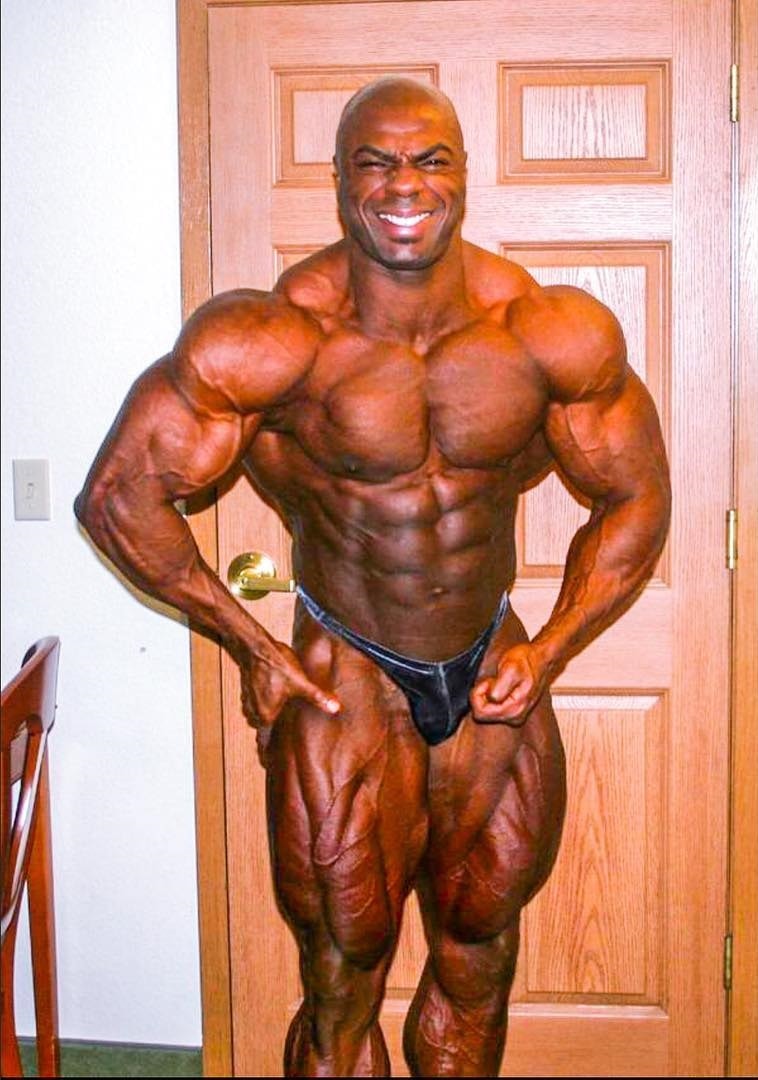 Toney Freeman posing shirtless in his house, looking ripped and huge