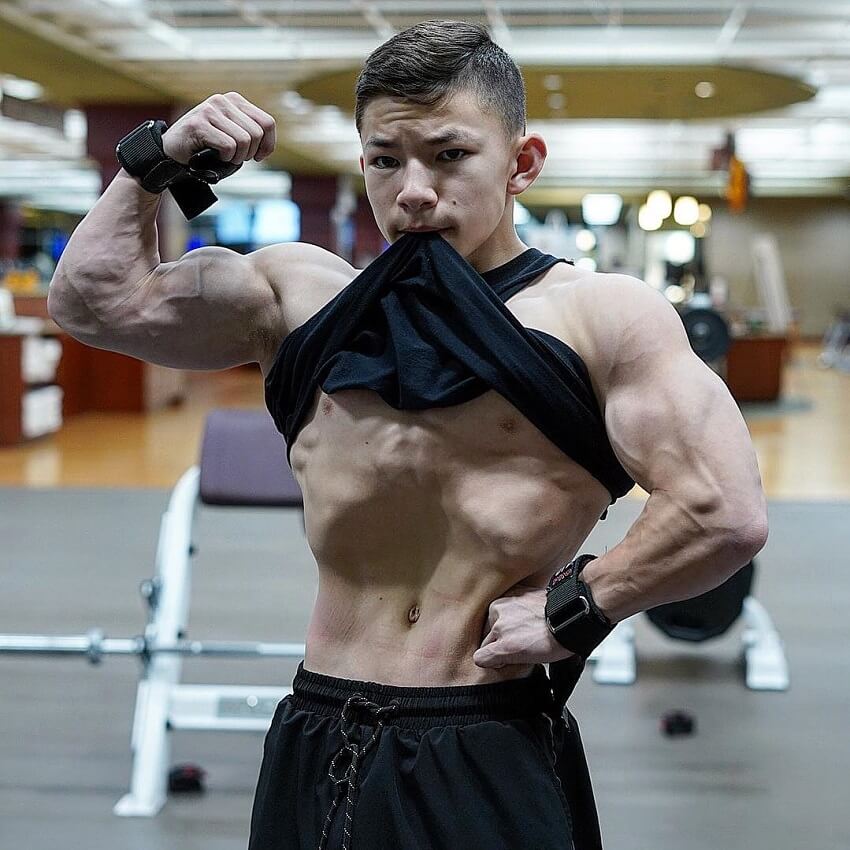 Tristyn Lee flexing his biceps looking fit and strong