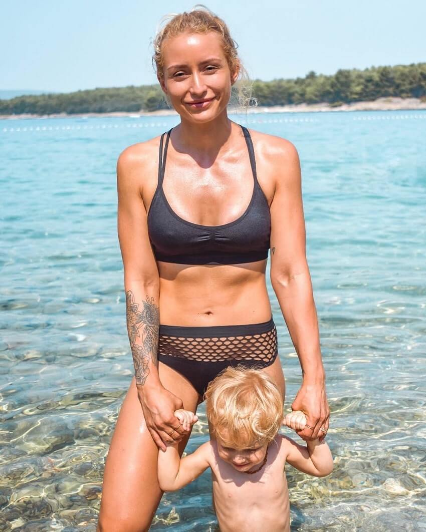 Wilda Fox posing with her son by the sea, looking fit and lean