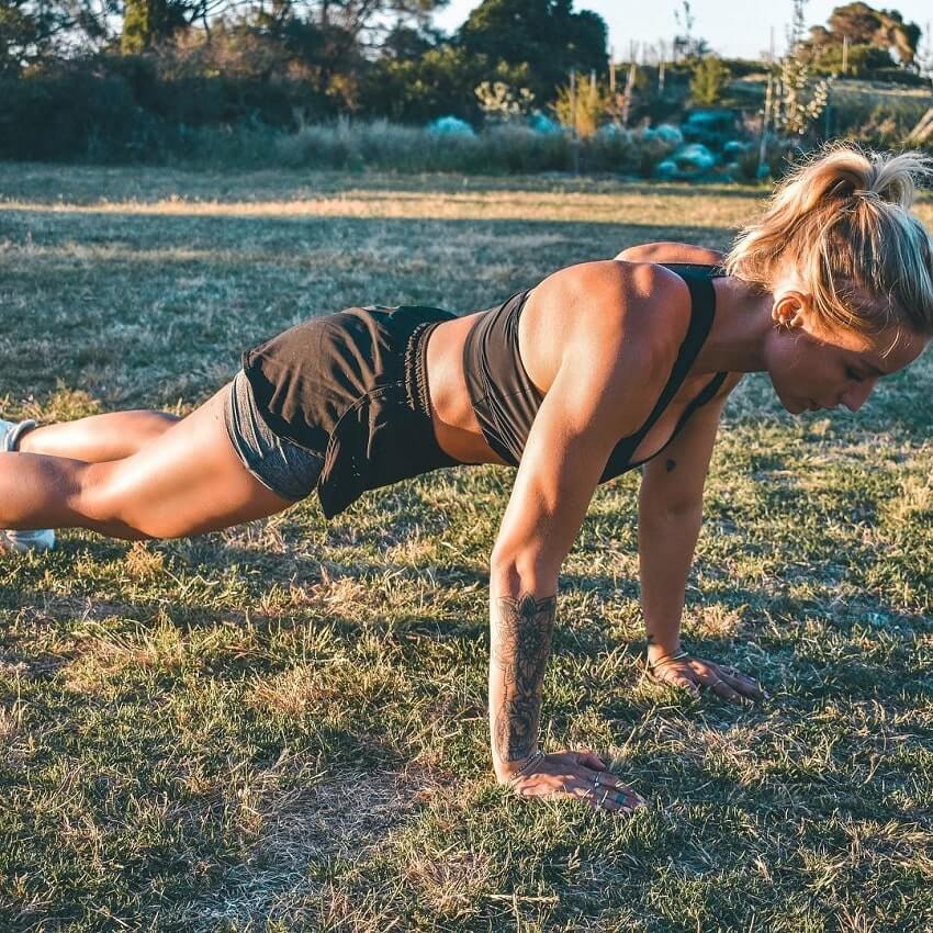 Wilda Fox doing pushups outdoors