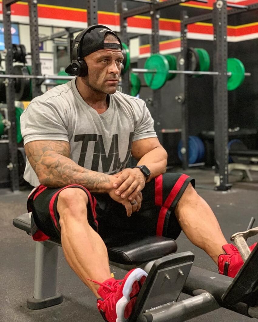 Aaron Polites resting between sets in a gym