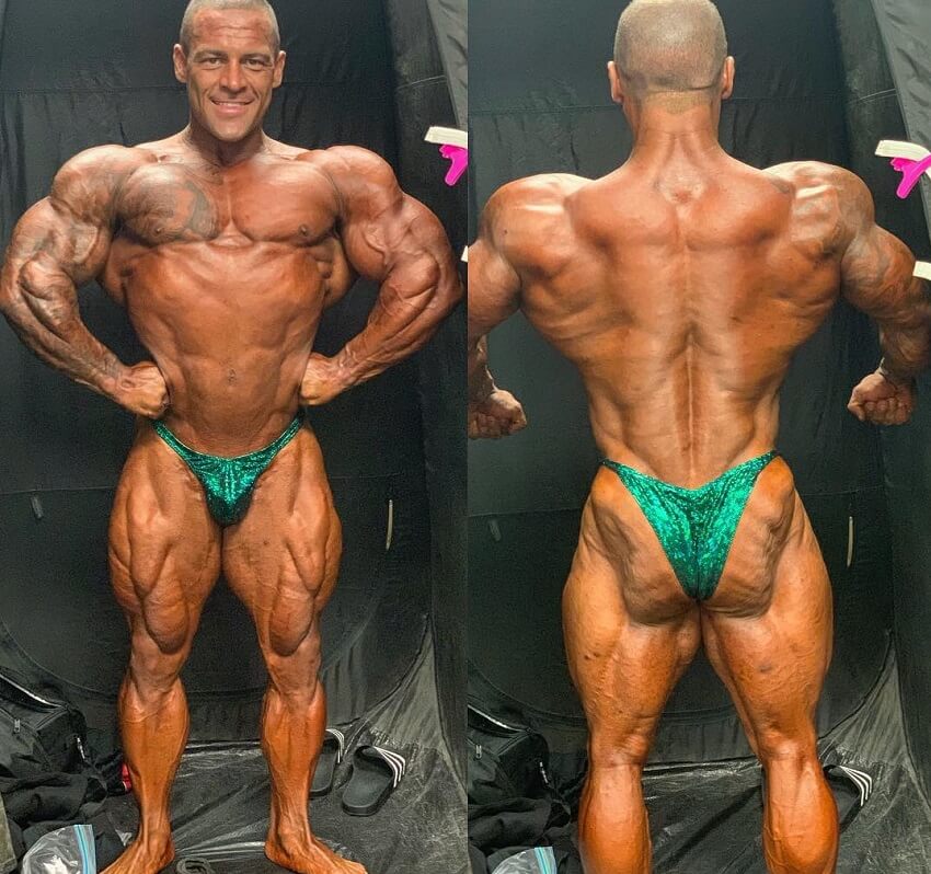 Aaron Polites standing backstage shirtless in his green bodybuilding trunks