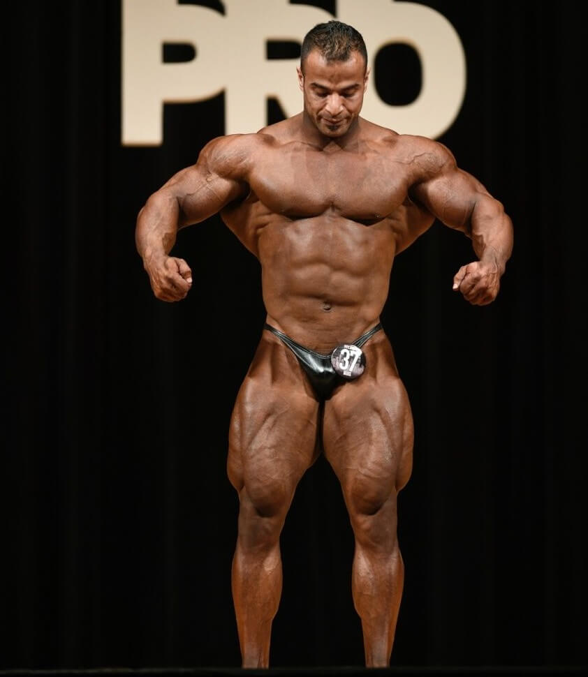 Ahmed Elsadany standing on the bodybuilding stage