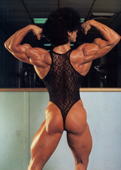 Christa Bauch doing a back double biceps pose