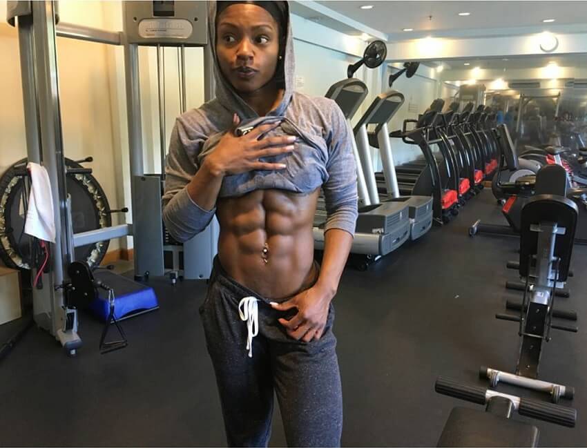 Cydney Gillon flexing her bulging abs in the gym