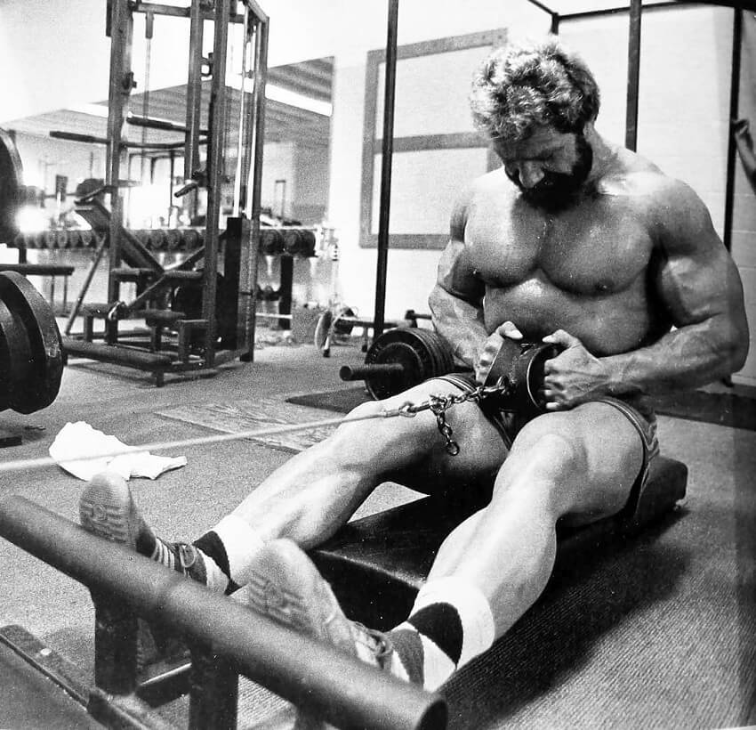 Jusup Wilkosz doing lat rows shirtless in the gym