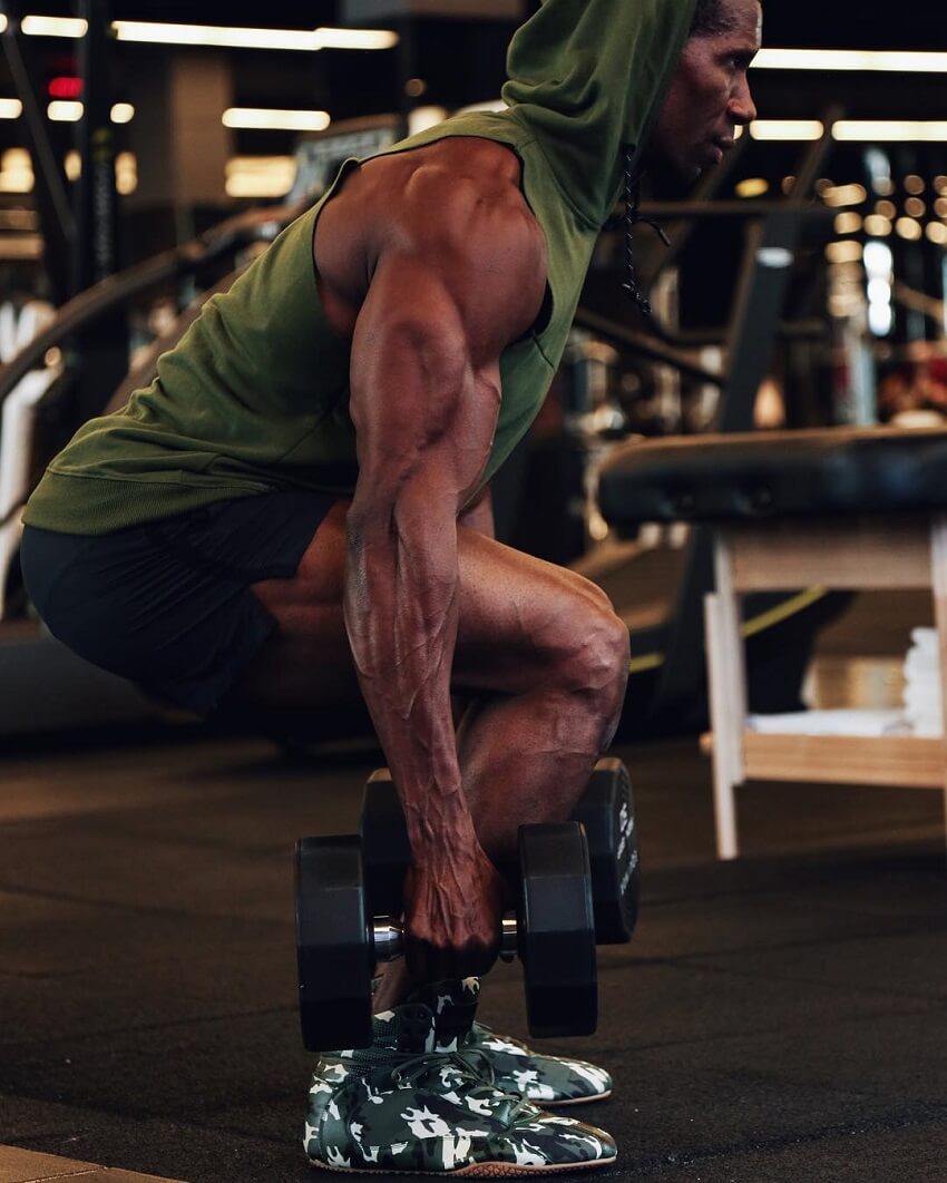 Max Philisaire training with dumbbells in the gym