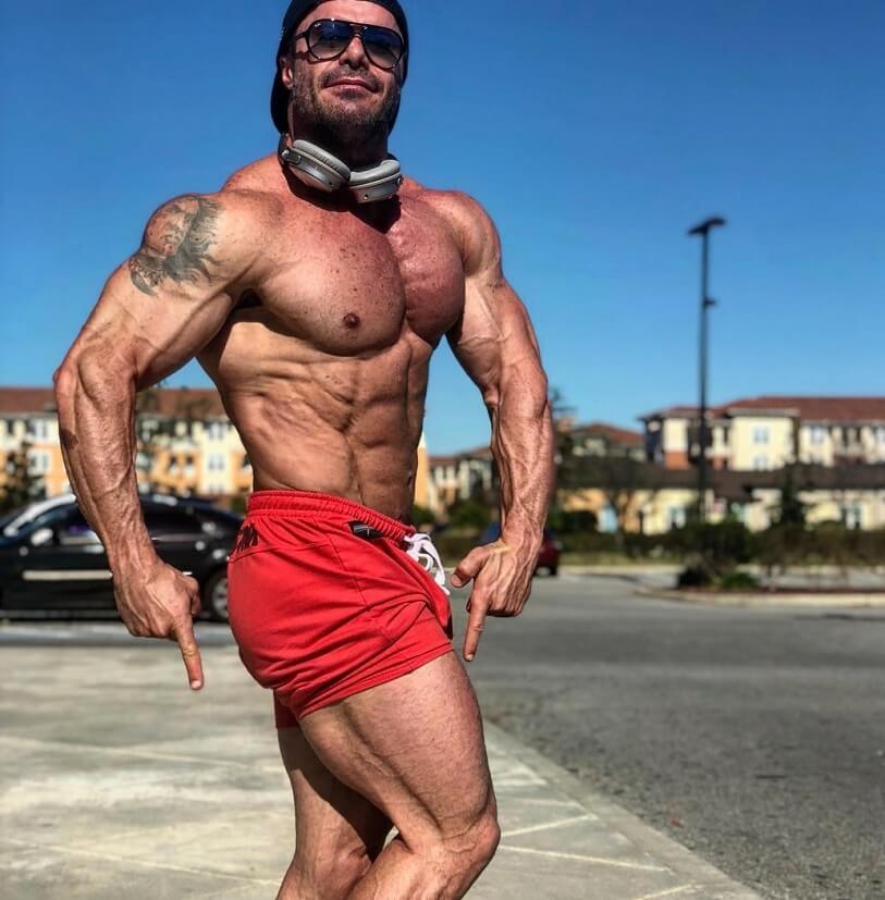 Renato Cariani flexing shirtless outdoors in the sun