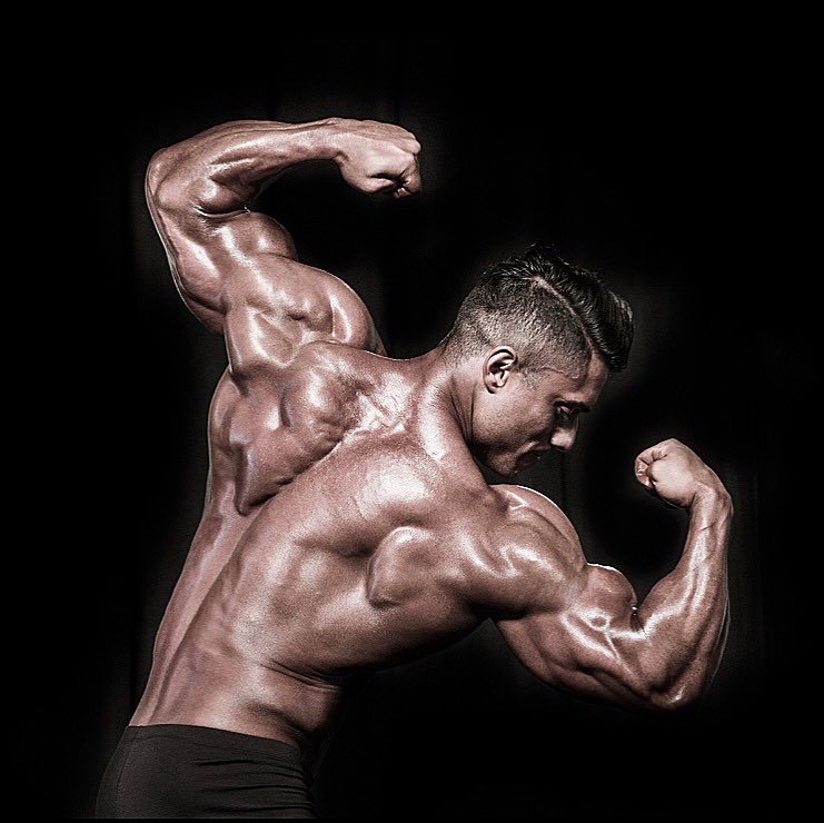 Stephen Pinto doing a rear double biceps pose