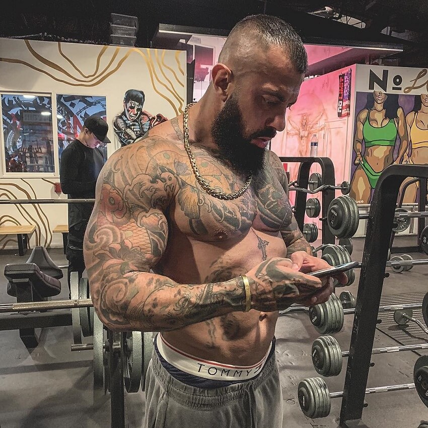Jack Torosian standing shirtless on his gym