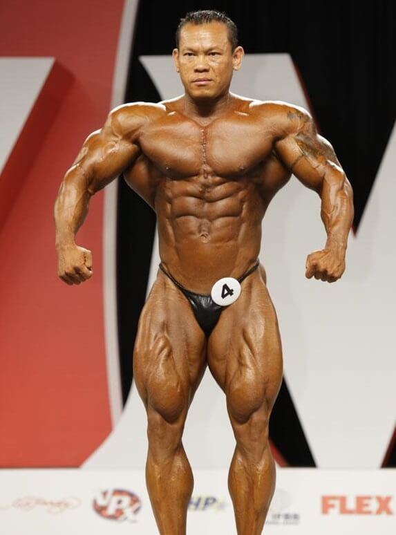 Kris Dim front lat spread in a bodybuilding contest