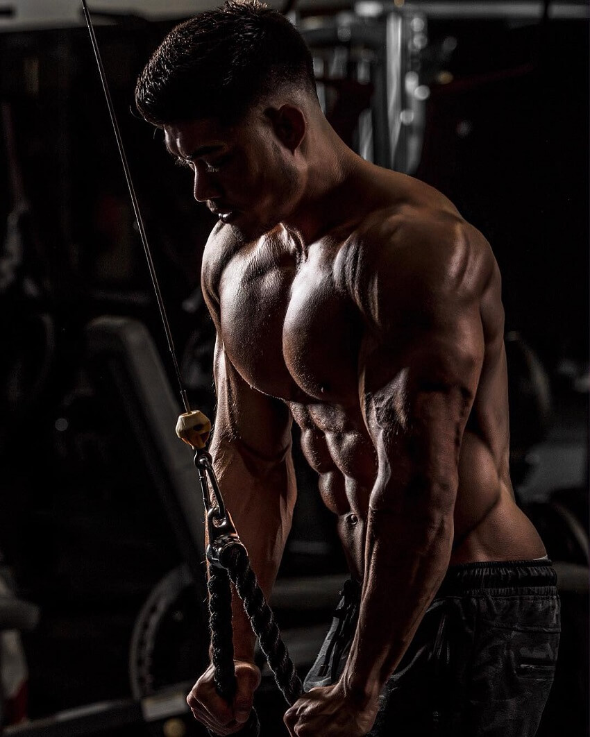 Nicolas Iong doing shirtless triceps extensions