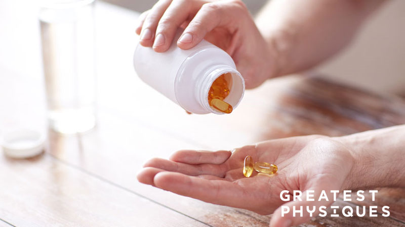 Man tipping multivitamins into his hand