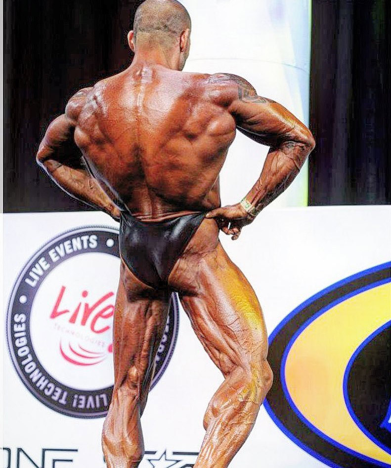 Marcello Rafaelli doing rear lat spread on the bodybuilding stage