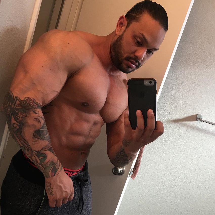 Mark Anthony taking a selfie of his ripped and swole physique