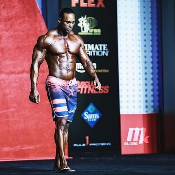 Mark Anthony walking down the Mr. Men's Physique Olympia stage