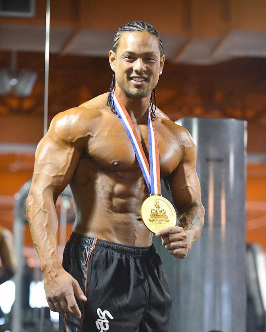 Mark Anthony posing with a gold medal