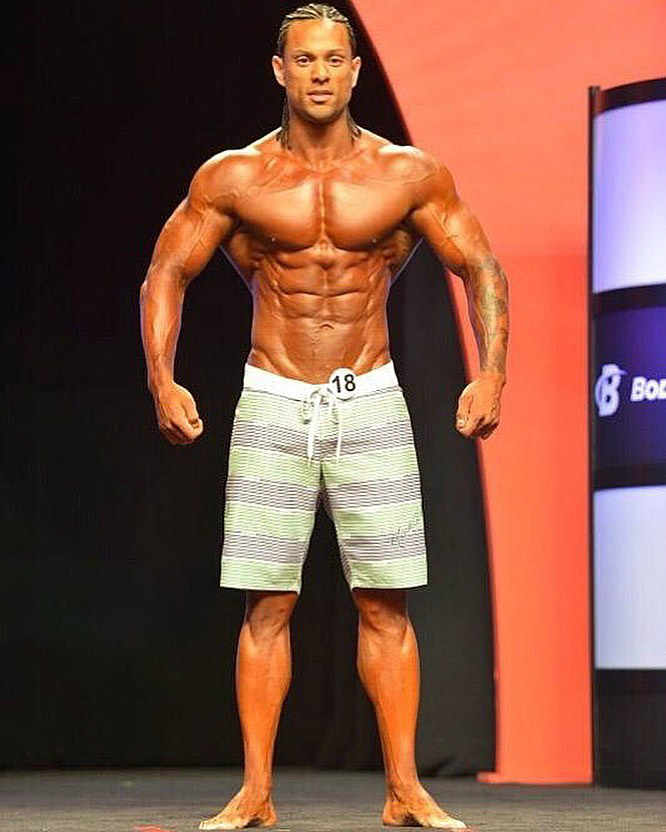 Mark Anthony posing shirtless on the Men's Physique stage