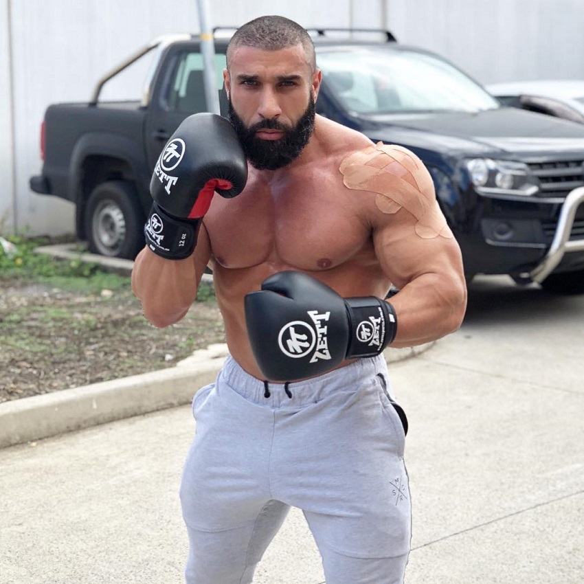 Basem Altakrity posing shirtless with boxing gloves