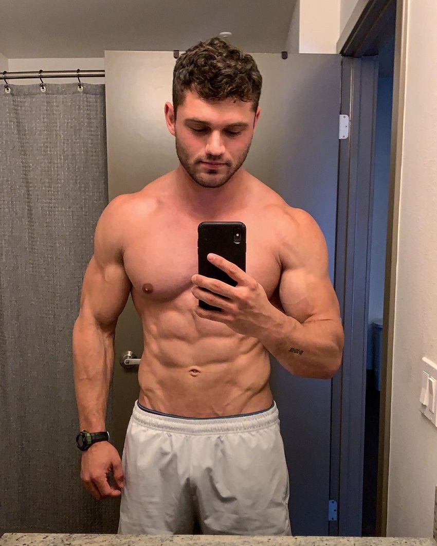 Chris Clark showcasing his ripped physique in the mirror