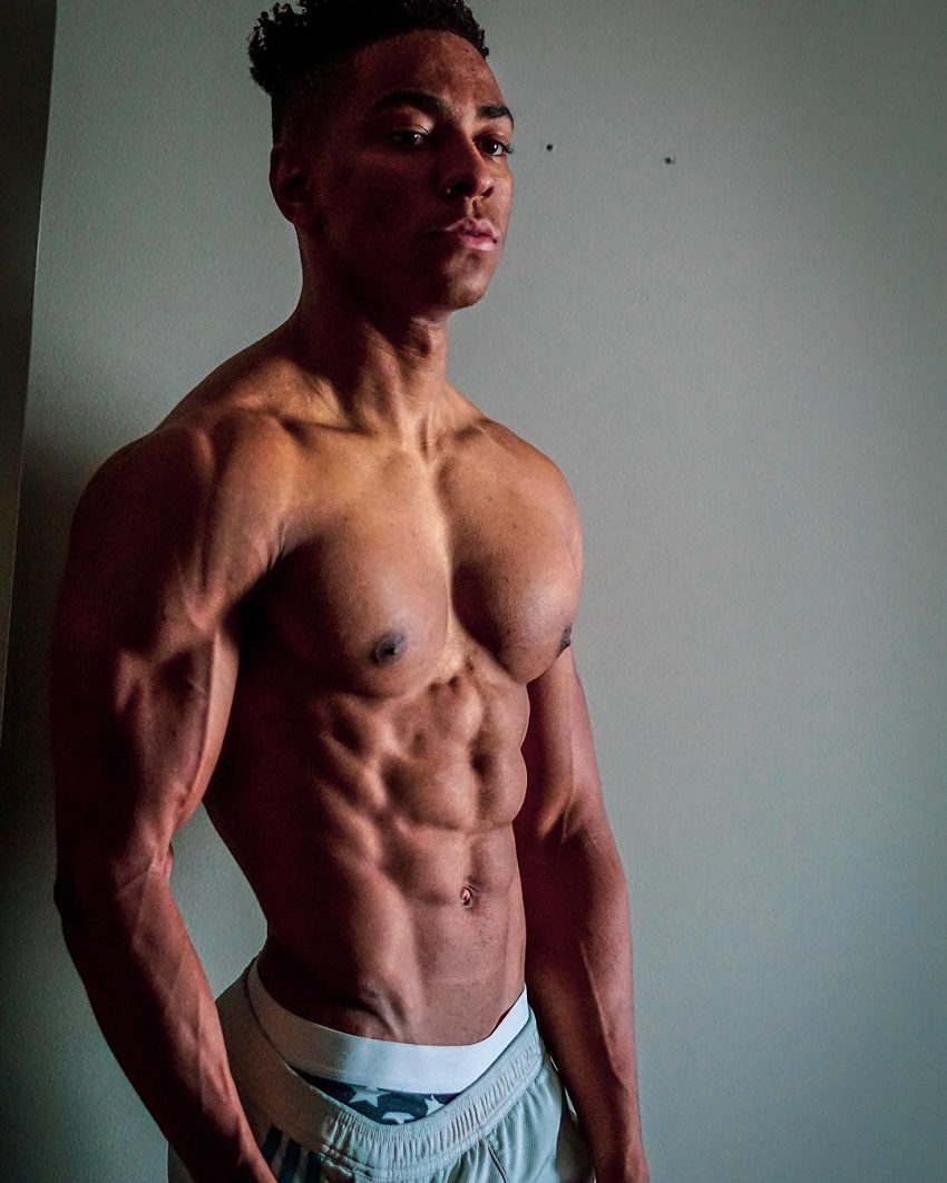 Evan Johnson posing shirtless looking ripped