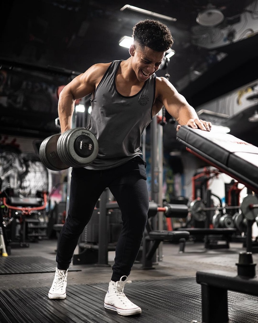 Michael Smith doing dumbbell rows in the gym