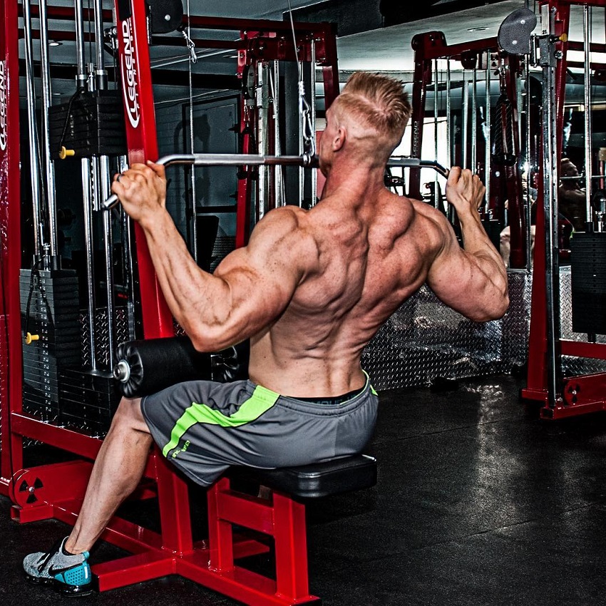 Brandon Budlong training his back shirtless in the gym