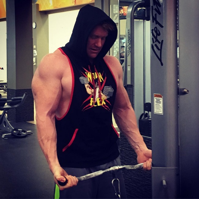 Brandon Budlong training in a sweatshirt tank top in the gym