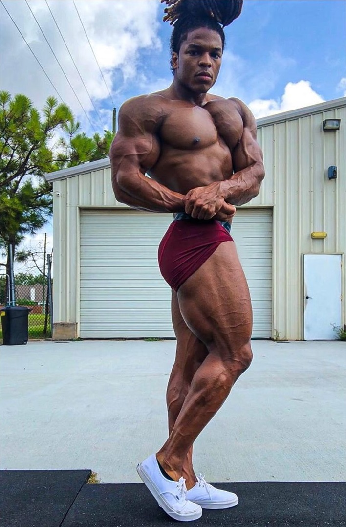 Jay Coss doing a side chest pose looking lean and fit