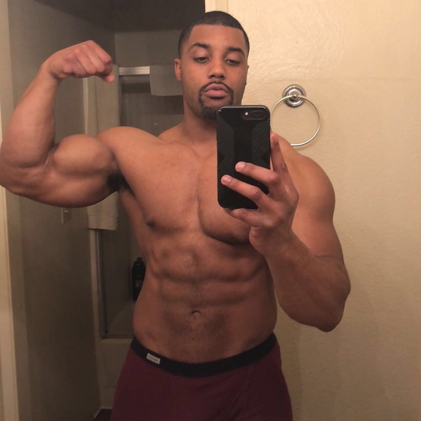 Mark White flexing his biceps in mirror