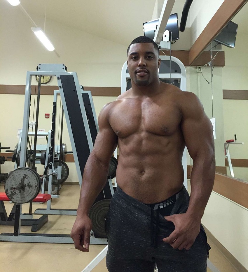 Mark White posing shirtless in the gym looking swole and lean