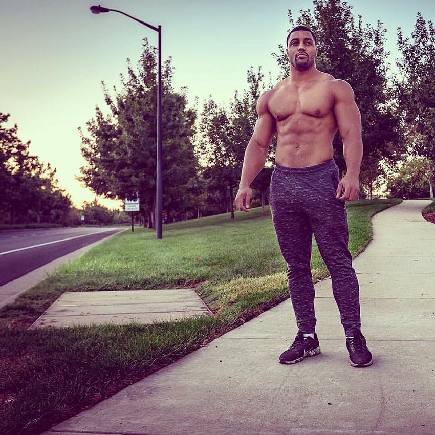 Mark White standing shirtless on the sidewalk