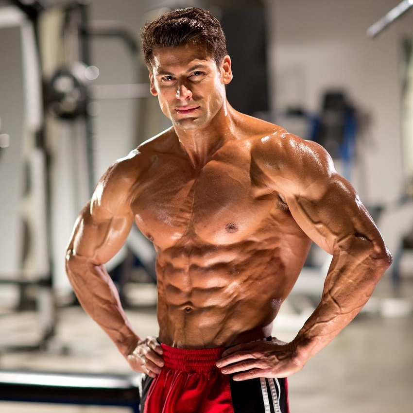 TJ Hoban posing shirtless in a professional fitness photo shoot