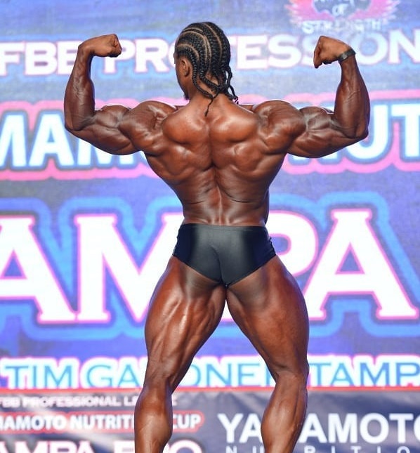 Rickey Moten performing the back double biceps bodybuilding pose at Mr. Olympia Classic Physique