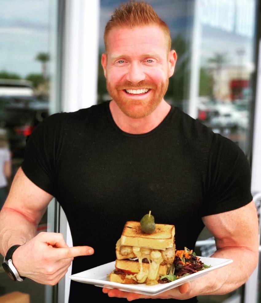 Brandon Budlong showing his food plate looking lean and fit