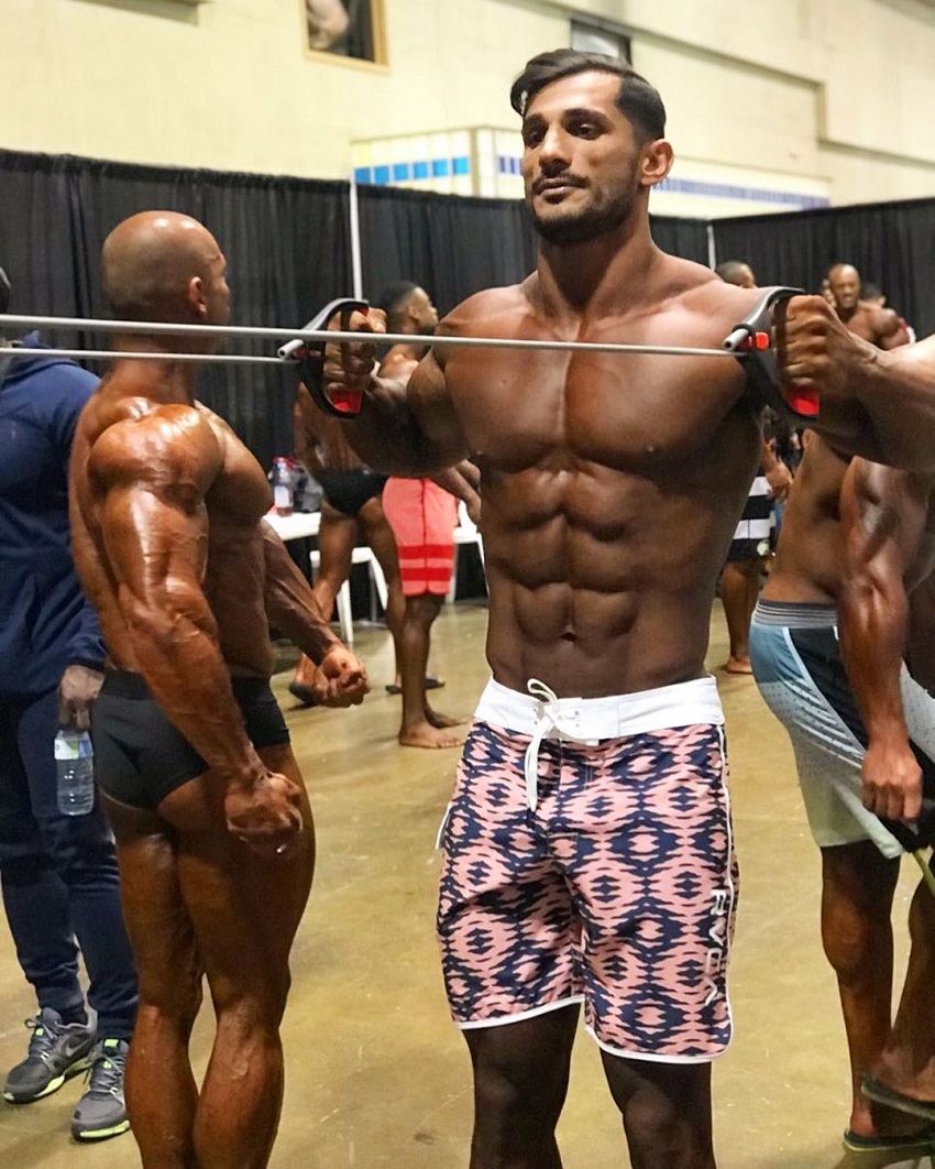 Akbar Sarbaz warming up in the backstage during a bodybuilding show