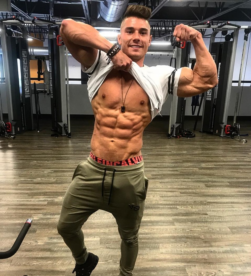 Bryan McCormick flexing his bulging abs and biceps