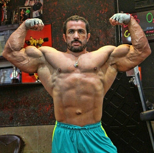 Mojtaba Notarki doing front double biceps pose shirtless