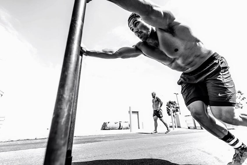 Garret Fisher training shirtless for CrossFit outdoors