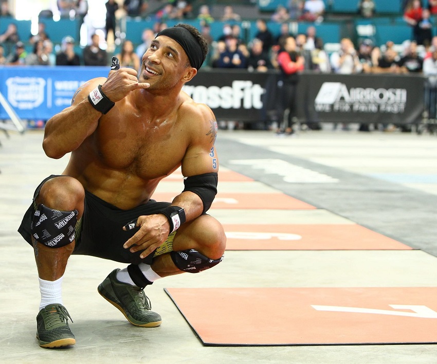 Neal Maddox shirtless in crouch position during a CrossFit contest